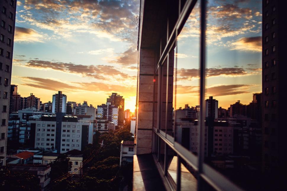 Person sitting quietly by a window at sunset in reflective mood, symbolizing acceptance and understanding.