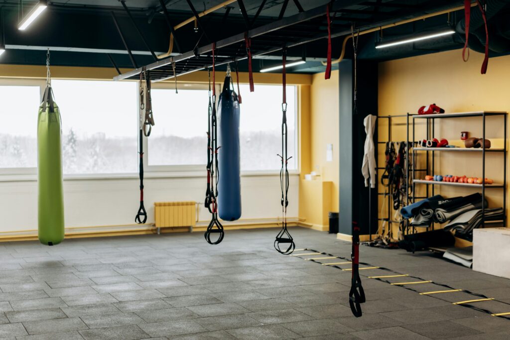 Open gym space with both cardio machines and lifting platforms visible in same frame.