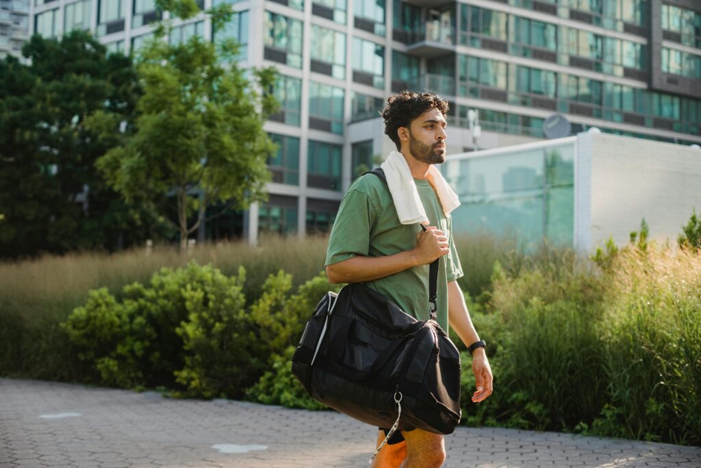 Man walking out of a quiet gym after finishing his workout