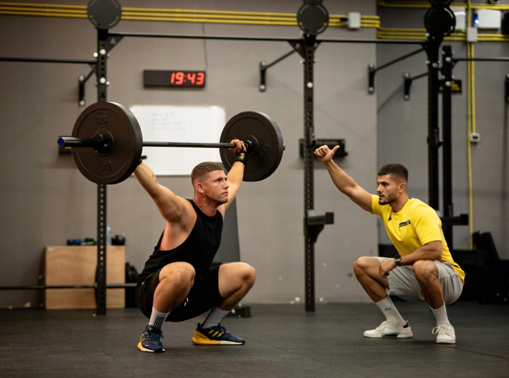 Man performing barbell squats during an early morning full body workout session