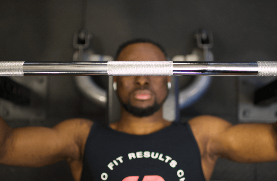 Man bench pressing a heavy barbell during a focused chest workout