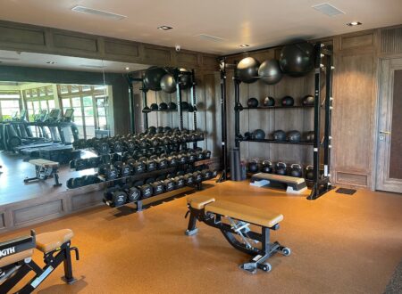 Man sitting alone on gym bench after workout looking thoughtful about fitness consistency