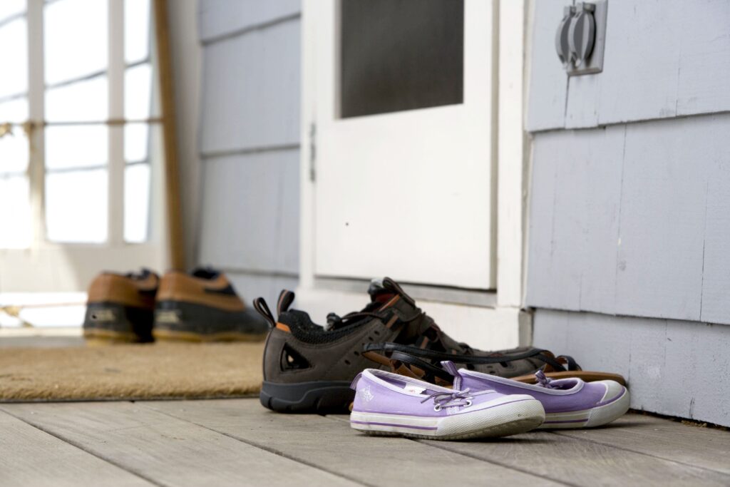 Simple workout shoes on doorstep representing small consistent habits