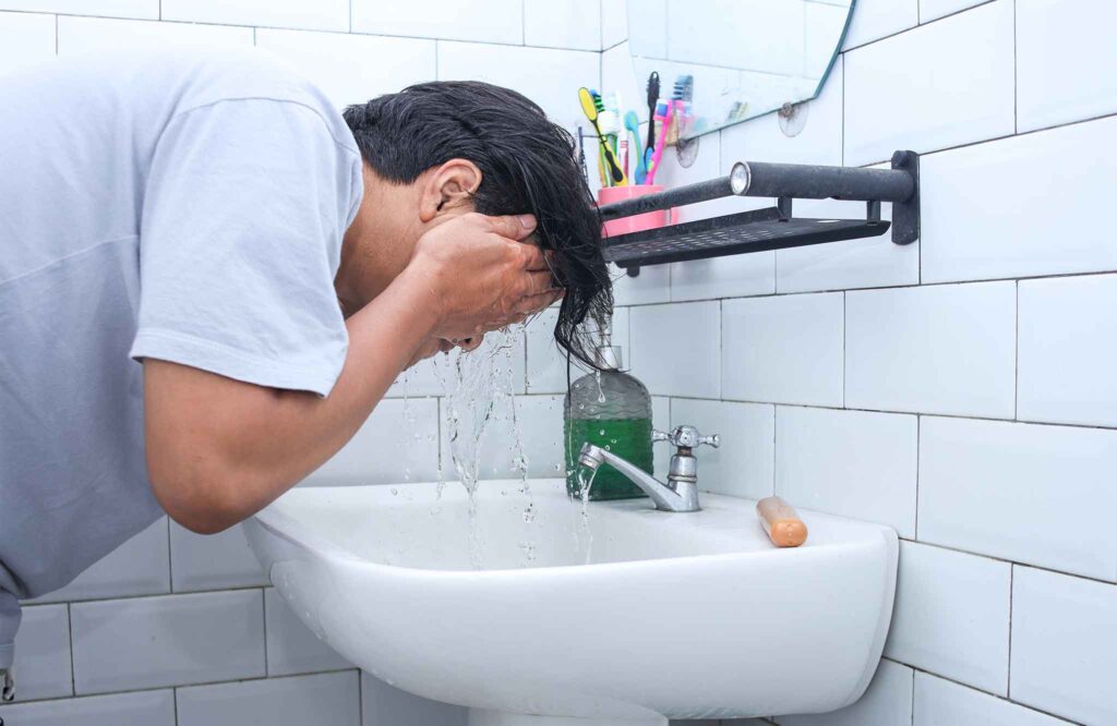 Tired gym-goer sitting on bench feeling mentally exhausted during workout