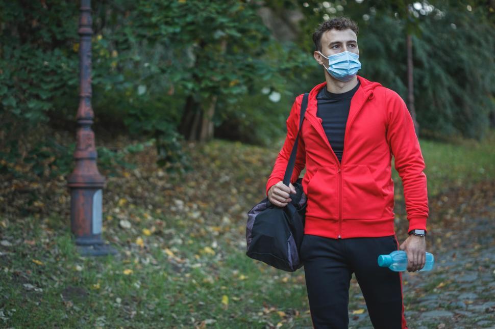 Person putting weights away after finishing gym workout alone