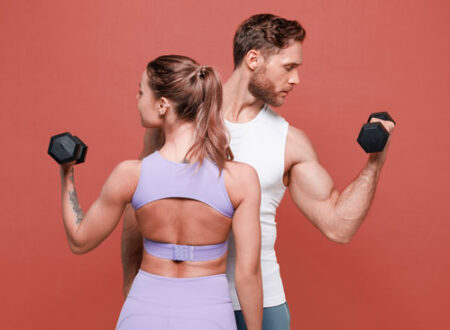 Beginner lifting weights in gym performing compound exercise for muscle growth