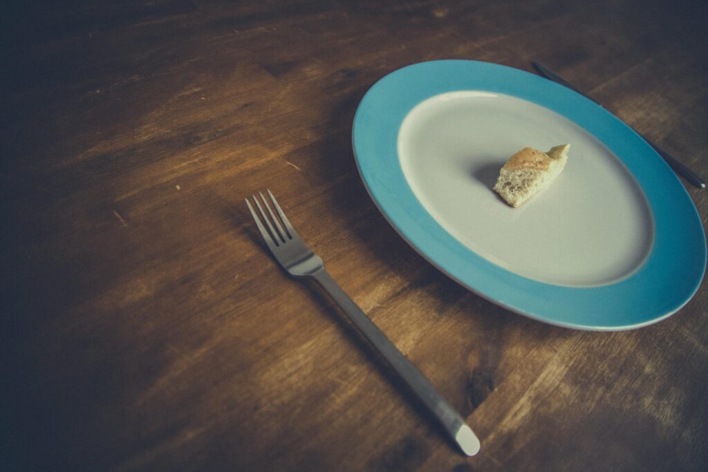 How Extreme Dieting Slows Your Metabolism Person feeling low energy due to extreme dieting and calorie restriction
