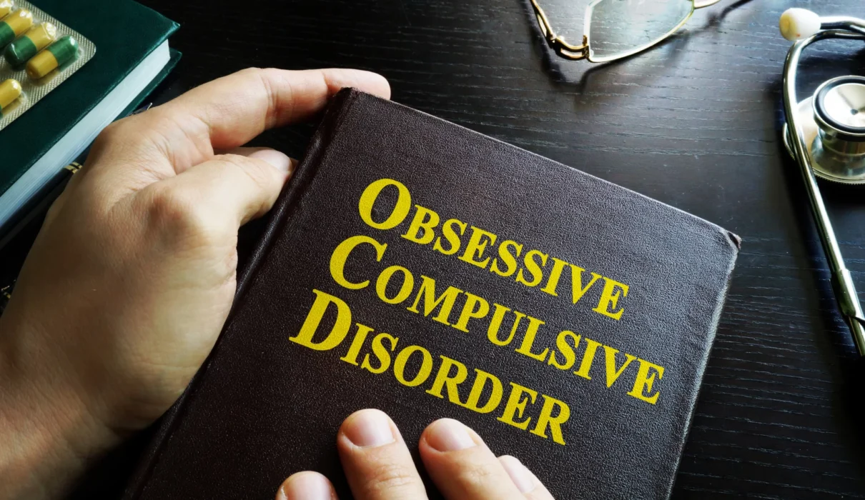 Person overwhelmed by intrusive thoughts representing obsessive-compulsive disorder cycle