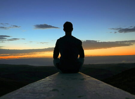 Person sitting calmly with hand on chest practicing breathing during a panic attack