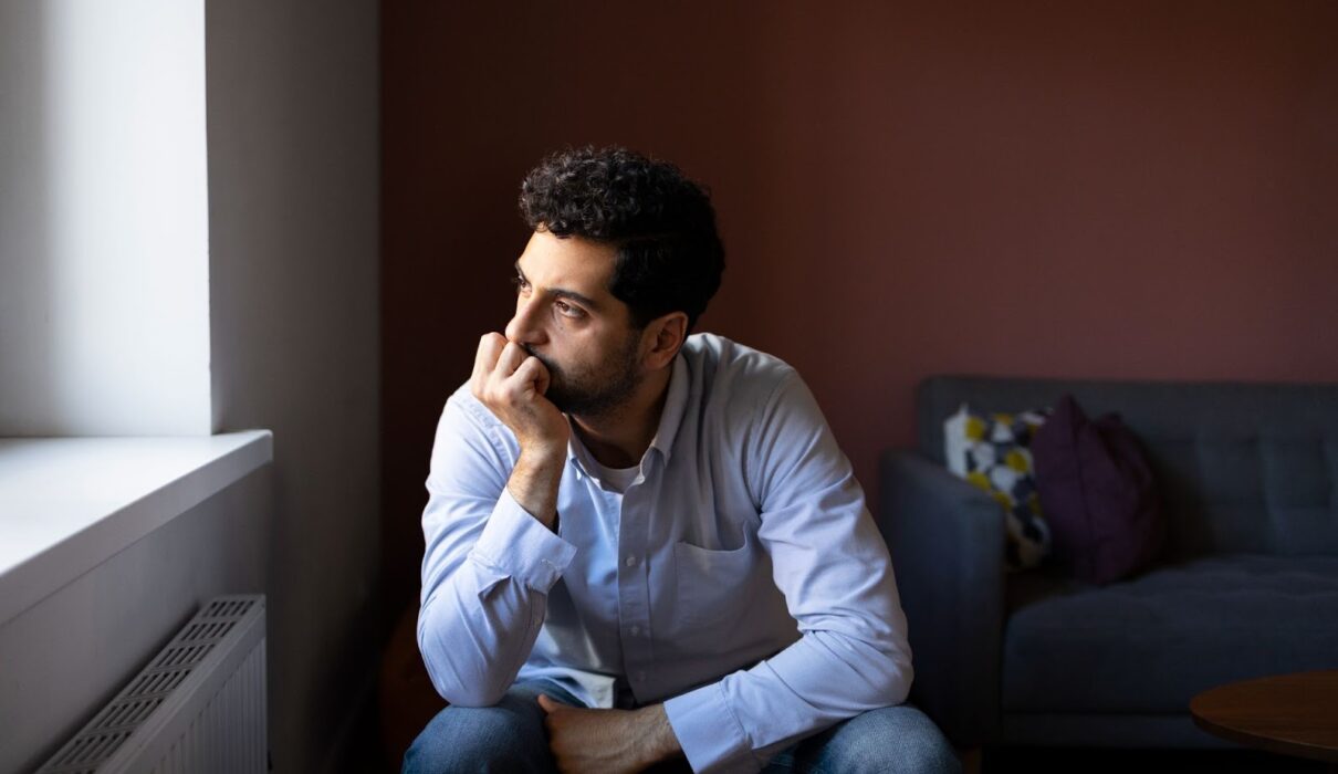 Person sitting alone in a quiet room reflecting internal thoughts related to schizophrenia and mental health