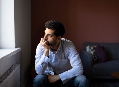 Person sitting alone in a quiet room reflecting internal thoughts related to schizophrenia and mental health