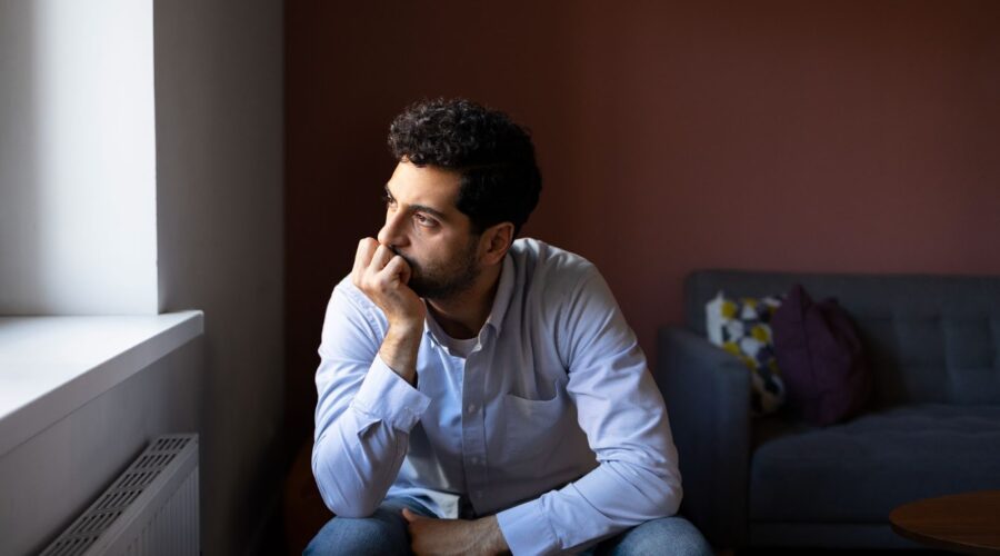Person sitting alone in a quiet room reflecting internal thoughts related to schizophrenia and mental health